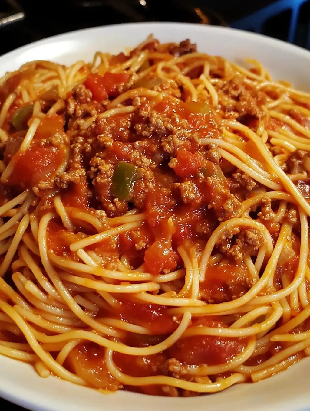 A mouthwatering bowl of spaghetti topped with hearty meat sauce.