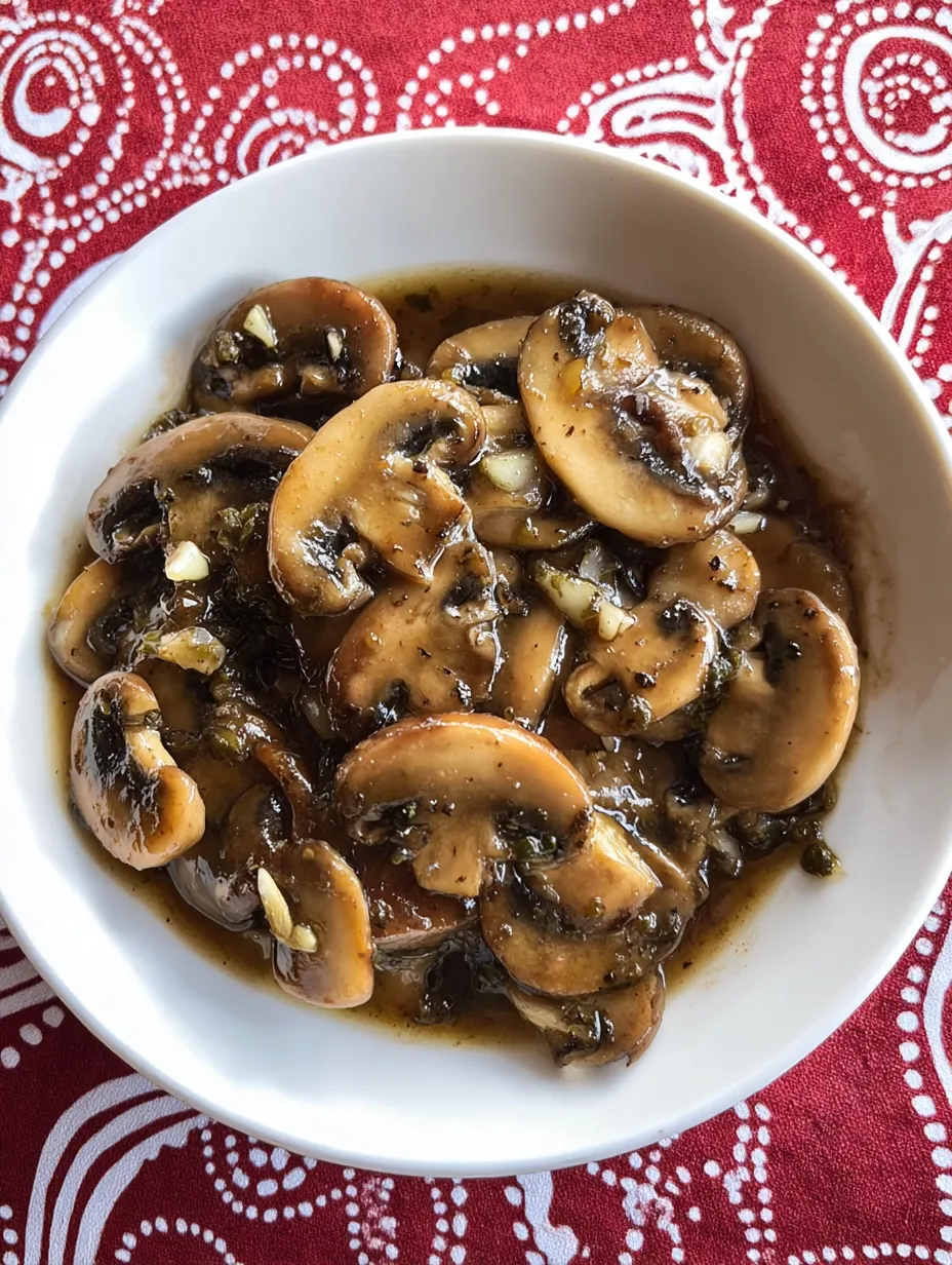 A white bowl filled with mushrooms.