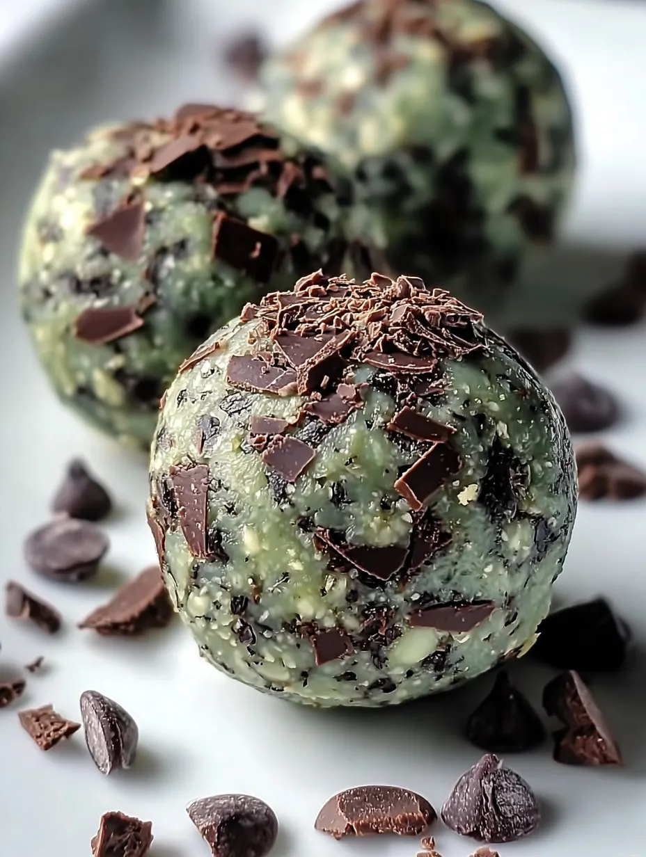 A pair of chocolate-coated green bites.