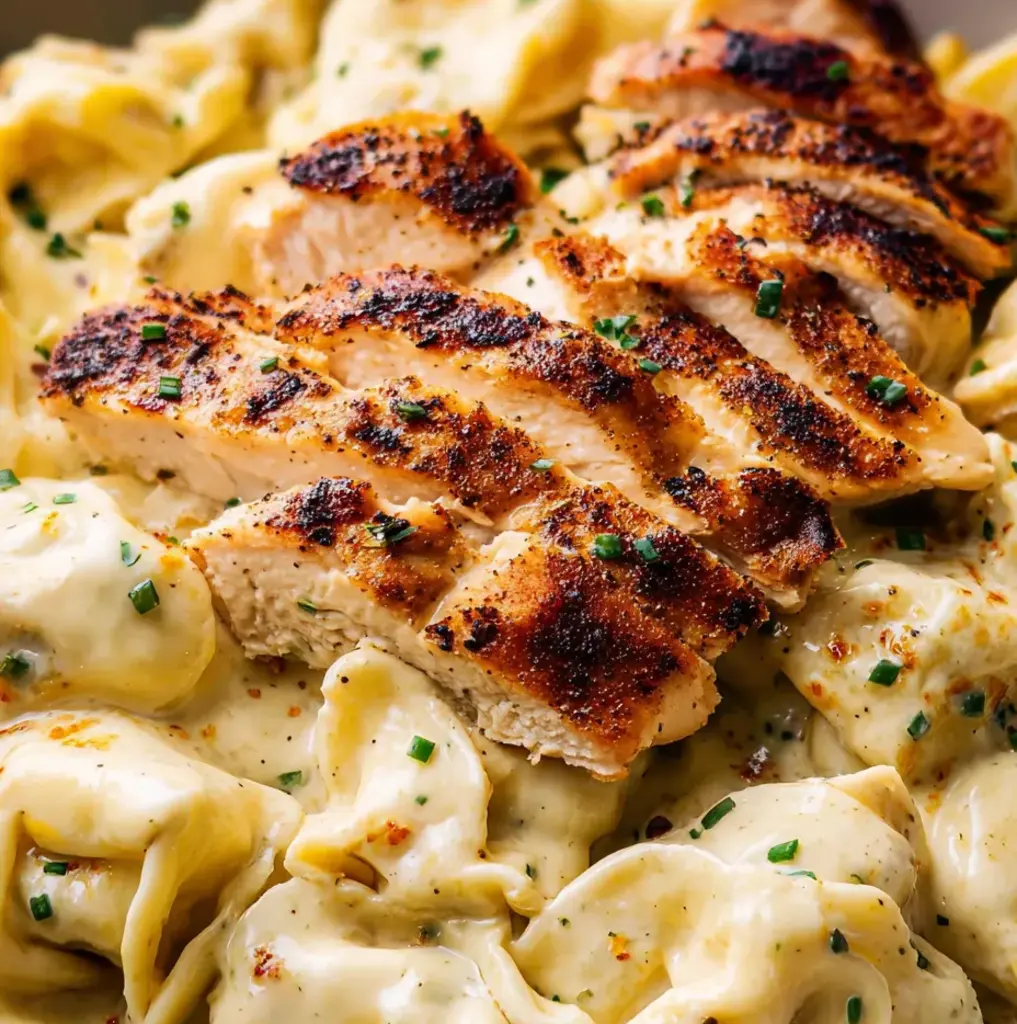 A plate of chicken-topped pasta.
