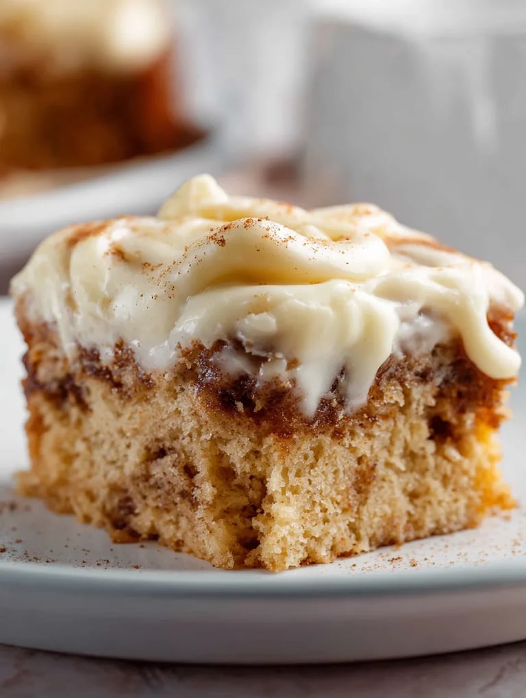 A slice of cinnamon roll poke cake.
