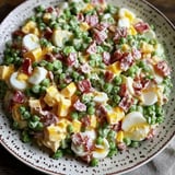 A plate with peas, eggs, and ham ready to eat