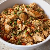 Rice and chicken with peas in a bowl.