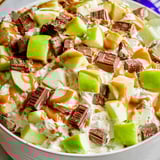 A bowl with fruit and chocolate sauce on top.