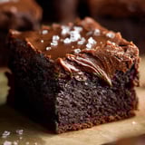 A piece of chocolate cake with creamy chocolate frosting.