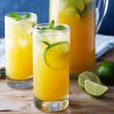 Orange juice in two glasses with fresh limes.