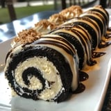 Sliced chocolate roll stuffed with Oreo cream on a plate.