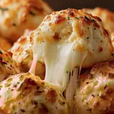 Bread balls covered in melted cheese.