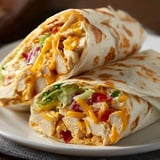 Plate holding two wraps filled with chicken.
