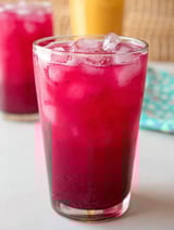 A glass of mango dragon fruit lemonade.