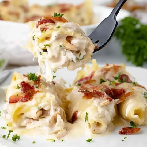 Someone using a fork to eat a delicious bite of food.