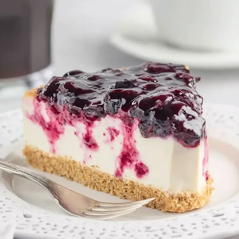 A slice of blueberry cheesecake on a plate.