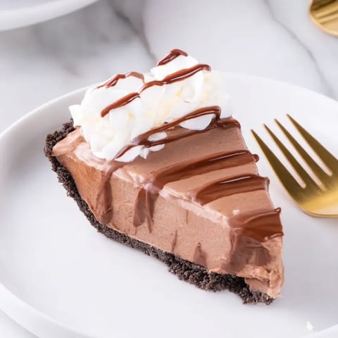 A slice of chocolate cake with whipped cream.