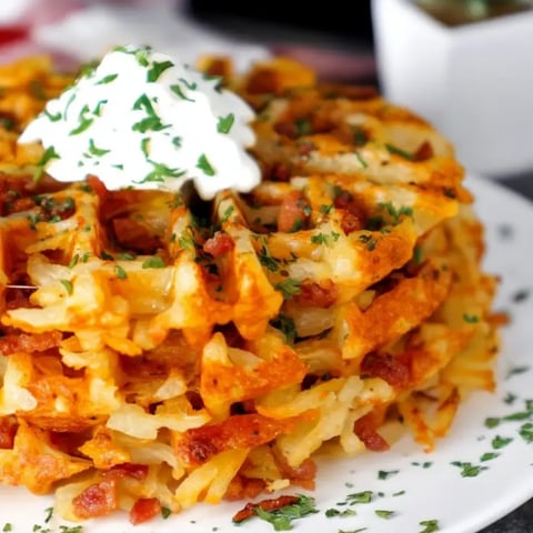 A plate of food with a dollop of sour cream on top.