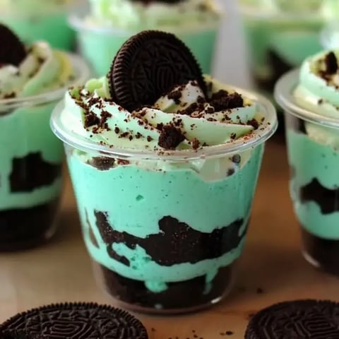 A cup of ice cream with a cookie on top.