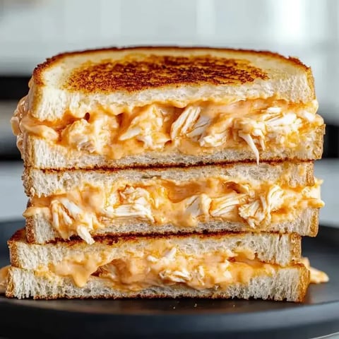 A sandwich with chicken and cheese on a plate.