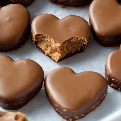 A chocolate heart treat with a bite missing.
