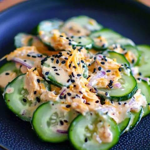 A plate of food with cucumbers and cheese.