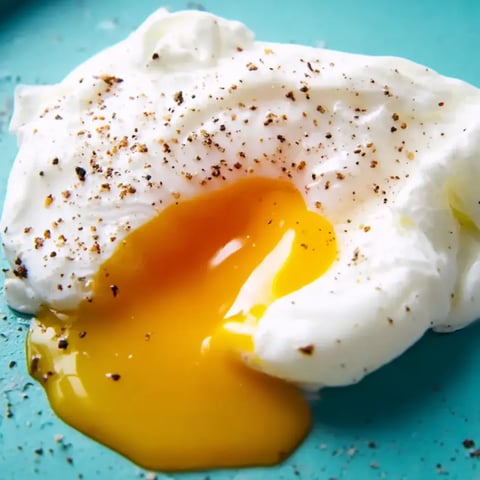 A fried egg yolk on a plate.