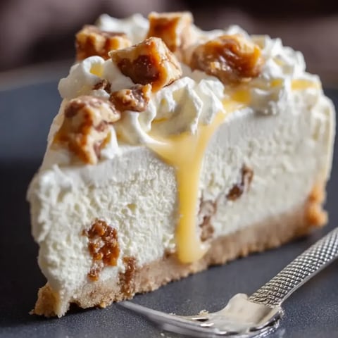 Creamy cheesecake slice topped with gooey caramel.