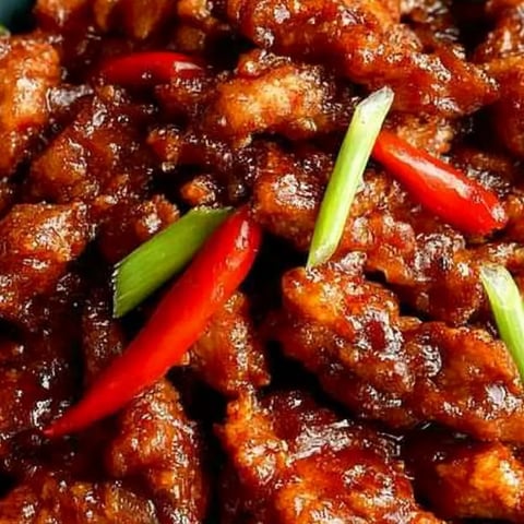 Crispy beef with bright peppers on a plate.