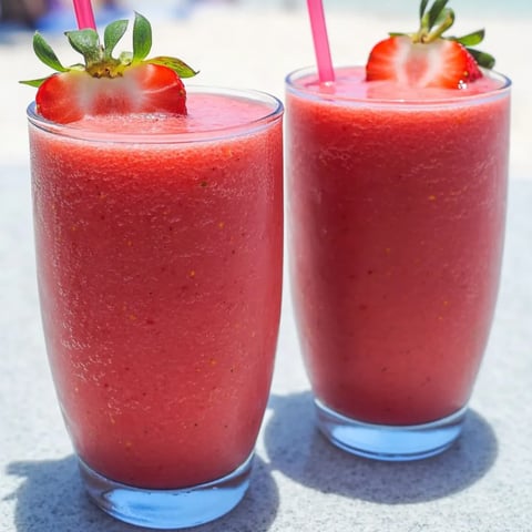 A couple glasses of strawberry frosty drinks.