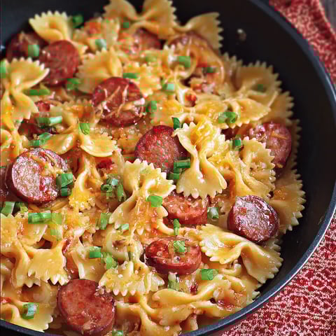 Pasta with sausage and veggies in a bowl.