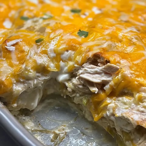 Slice of cheesy chicken pizza on a plate.