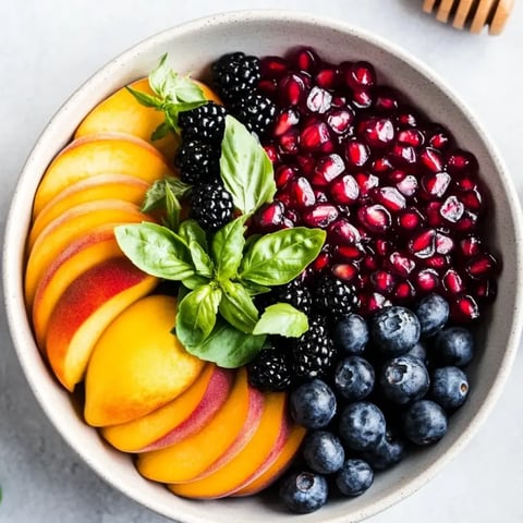 A bowl loaded with berries and colorful fruit chunks.