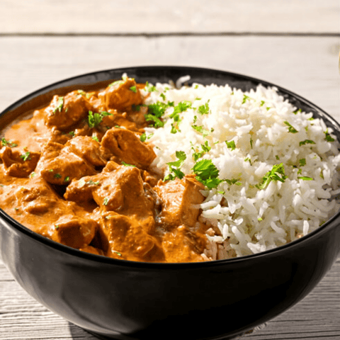 A bowl filled with meat and rice.
