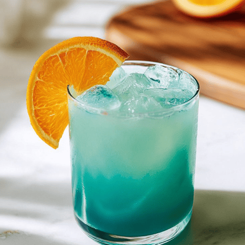 A glass filled with a bright blue drink, topped with a slice of orange.