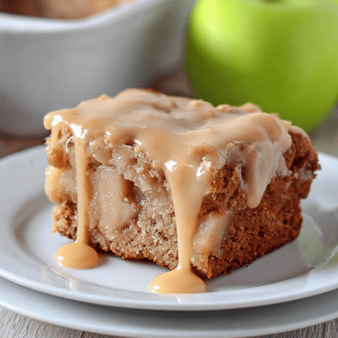 A slice of cake topped with a puddle of caramel sauce.