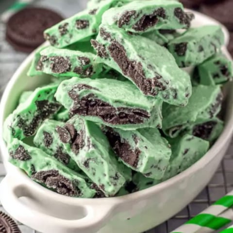 Bowl filled with green-tinted candy and chocolate.