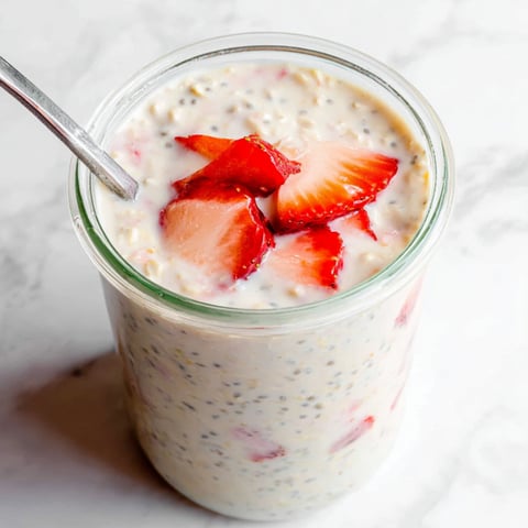 Cool yogurt and strawberries layered in a glass.