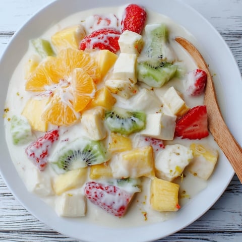 A white bowl filled with fruit.