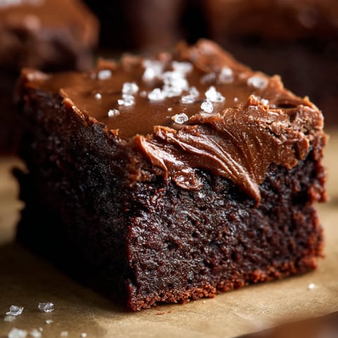 A piece of chocolate cake with creamy chocolate frosting.