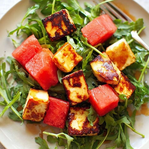 A plate of food with a fork and a knife.
