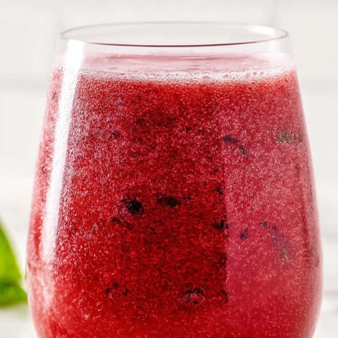 Glass filled with berry punch.