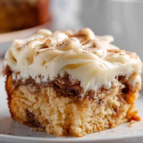 A slice of cinnamon roll poke cake.