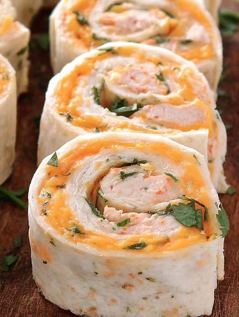 A taco roll up with chicken and cheese.