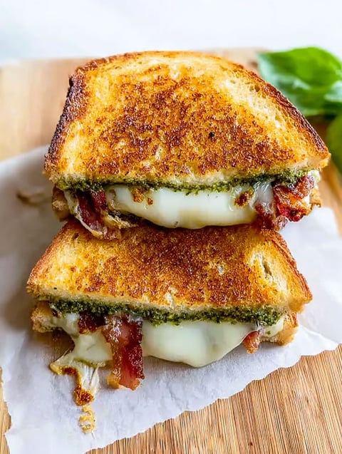 A grilled cheese sandwich with pesto and bacon.