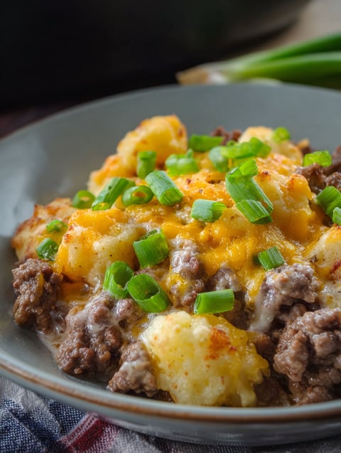 A plate of food with a green topping.